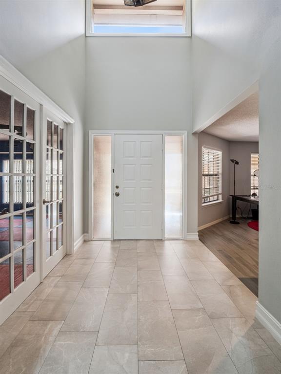 A single-story house with a tan exterior and stone accents sits behind a grassy yard — 5314 SHADYWOOD LANE, ORLANDO, FL