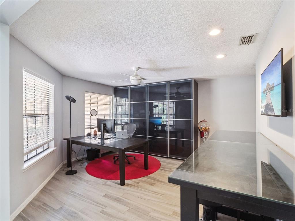 A single-story tan house with a dark roof sits behind trees on a grassy lot — 5314 SHADYWOOD LANE, ORLANDO, FL