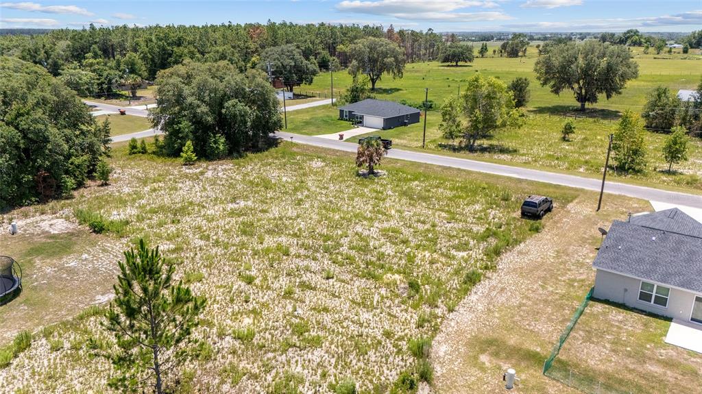 An aerial view shows a vacant, sandy lot next to a house and a road — 0 MALAUKA LOOP, OCKLAWAHA, FL