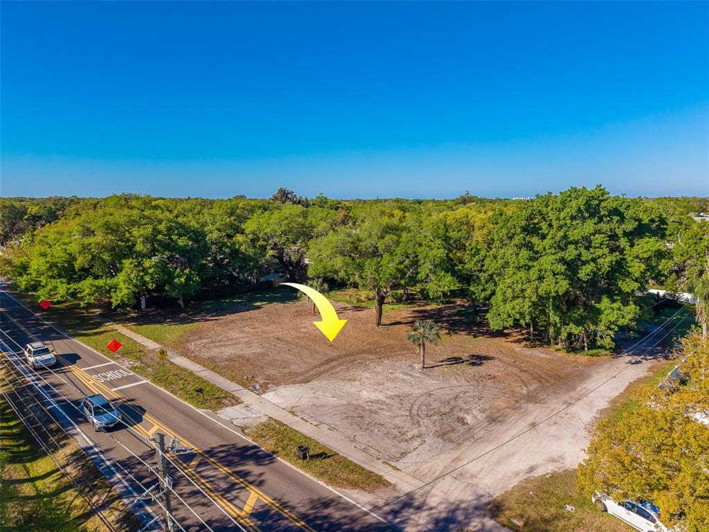 An aerial view of a vacant, cleared rectangular lot bordered by a road and trees — 11625 131ST STREET, LARGO, FL