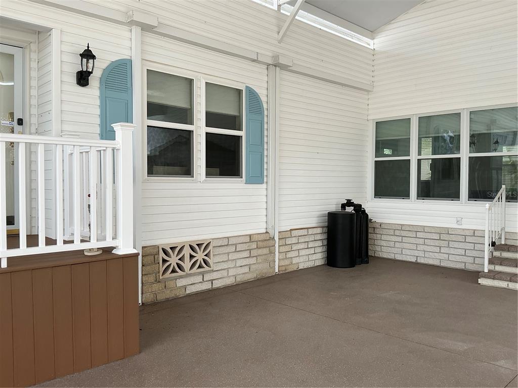 A white house with a two-car garage and a concrete driveway under a cloudy sky — 236 ALLIES PASS PASS UNIT 363, FROSTPROOF, FL