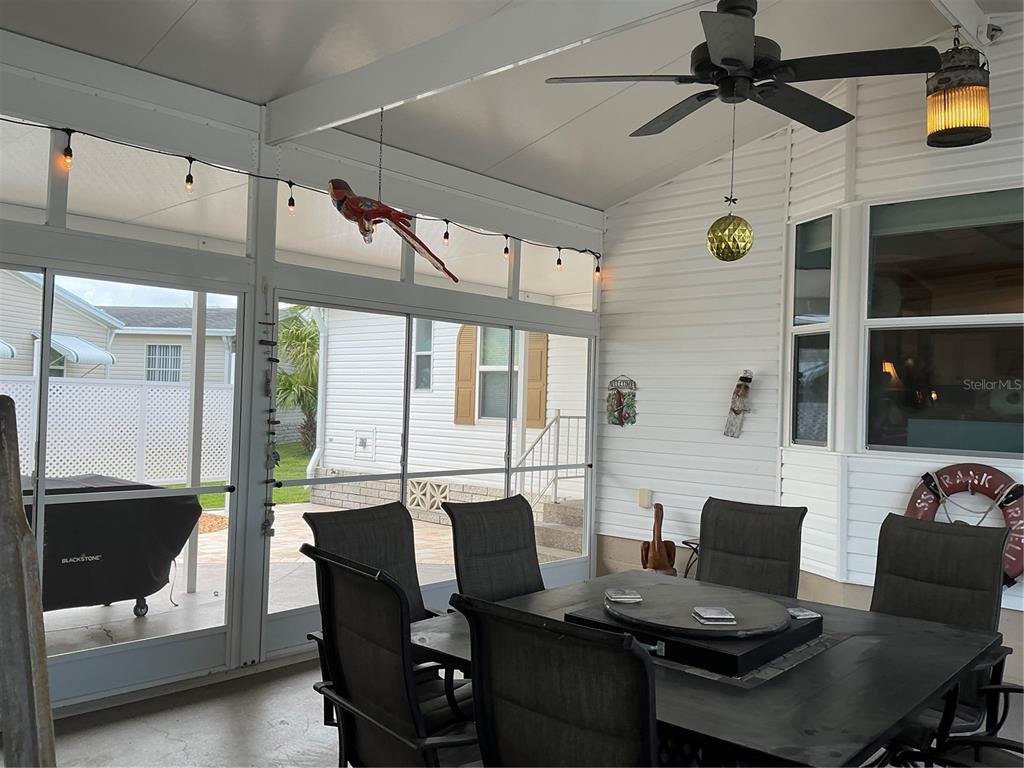A white mobile home with a carport housing a Cedar Creek fifth-wheel travel trailer — 236 ALLIES PASS PASS UNIT 363, FROSTPROOF, FL