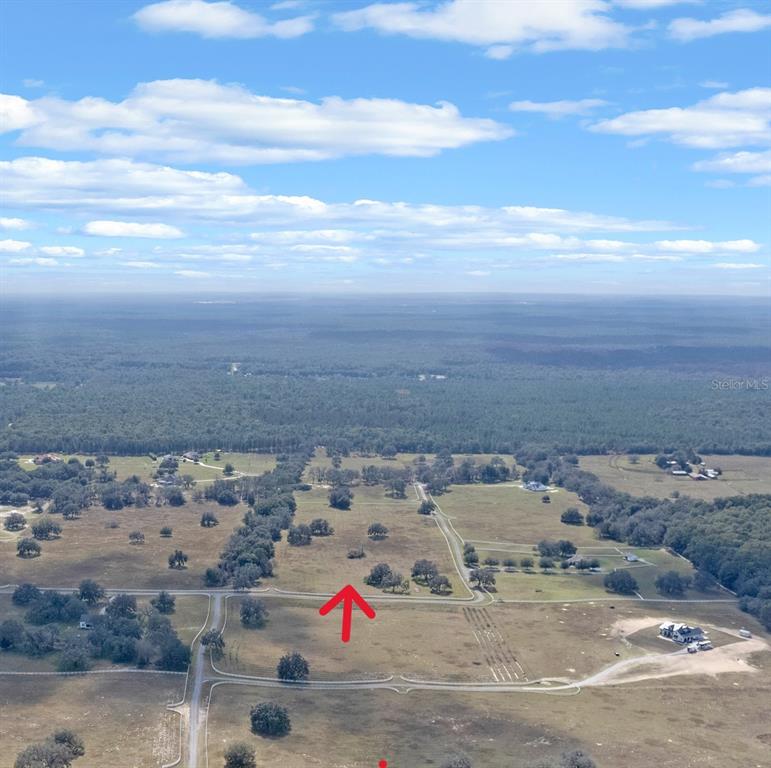 An aerial view shows a large, grassy rural lot with scattered trees and dirt roads — 14 EAGLE RIDGE, BUSHNELL, FL