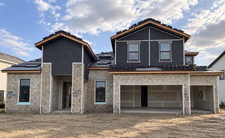 A construction site shows the concrete block walls of a house under development — 10645 SPRING SAPLING CIRCLE, PARRISH, FL