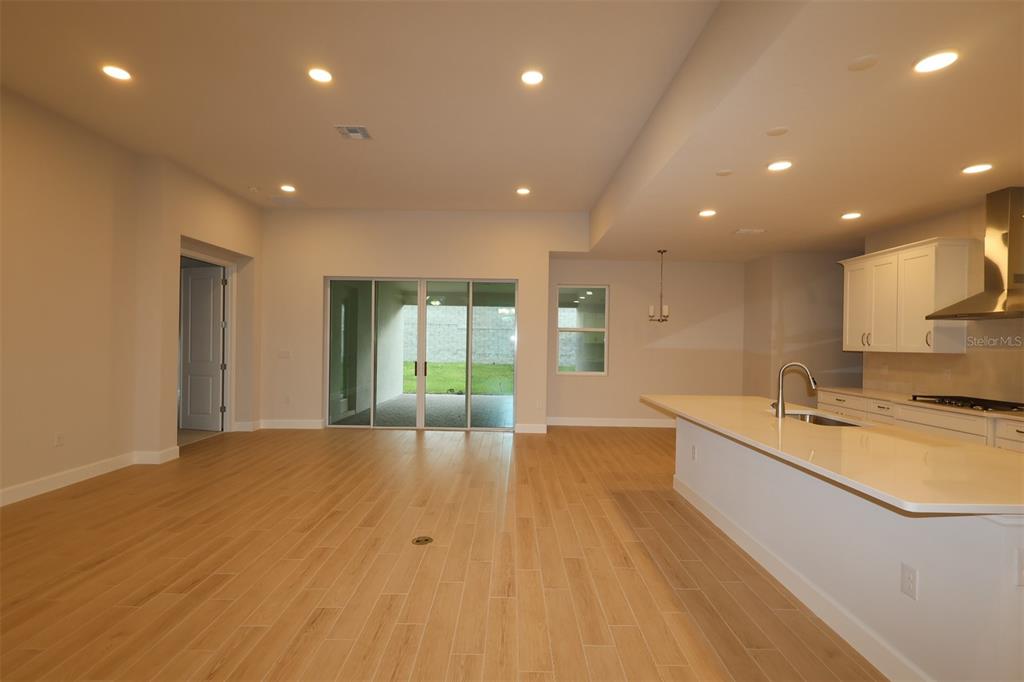 An empty room with beige walls, white trim, and an unfinished concrete floor — 3223 ROSEVILLE DRIVE, APOPKA, FL