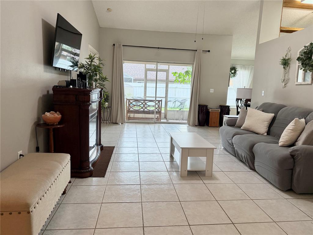 A single-story house with a beige stucco exterior, arched windows, palm trees, and a walkway — 908 45TH STREET E, BRADENTON, FL