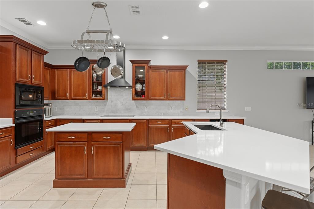 A two-story foyer features light tile flooring, arched entryways, and a white double front door — 14411 HAMPSHIRE BAY CIRCLE, WINTER GARDEN, FL