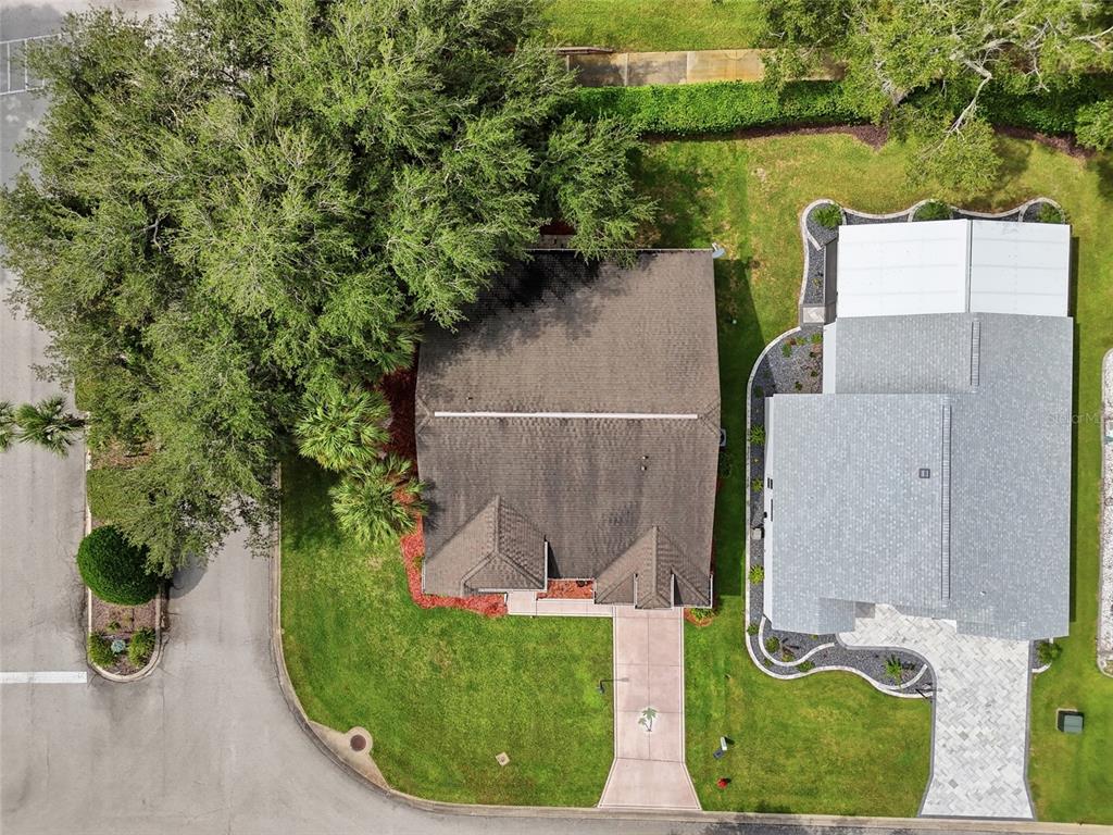 An aerial view shows two adjacent houses with driveways, lawns, and mature trees — 5350 ASTOR STREET, LEESBURG, FL