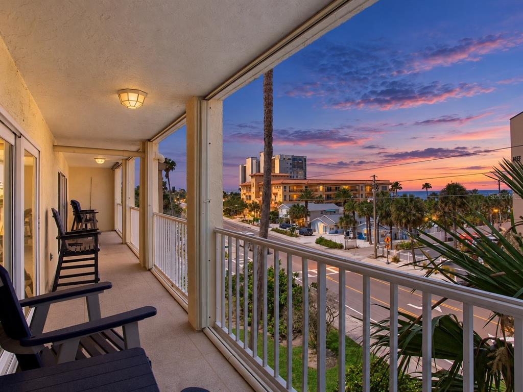 An aerial view of a multi-story peach-colored apartment building located on a sandy beach — 1005 GULF BOULEVARD UNIT 10, INDIAN ROCKS BEACH, FL