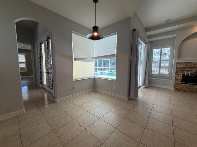 A single-story house with a stone facade, palm trees, and two cars in the driveway — 13856 GLYNSHEL DRIVE, WINTER GARDEN, FL
