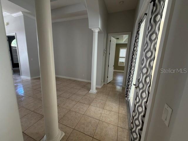 The exterior of a stone-faced house features an arched entryway and two arched windows — 13856 GLYNSHEL DRIVE, WINTER GARDEN, FL