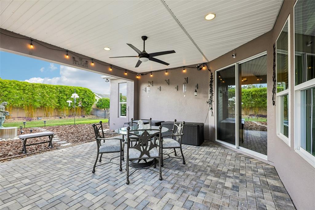 A single-story house with a stone facade, gray stucco, and a brick paver driveway — 508 NARROW VIEW LANE, GROVELAND, FL