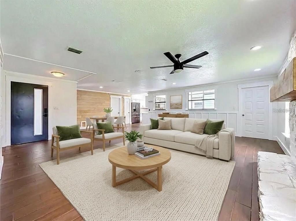 A living room features a beige sofa, two armchairs, a round coffee table, and wood flooring — 12756 POINSETTIA AVENUE, SEMINOLE, FL