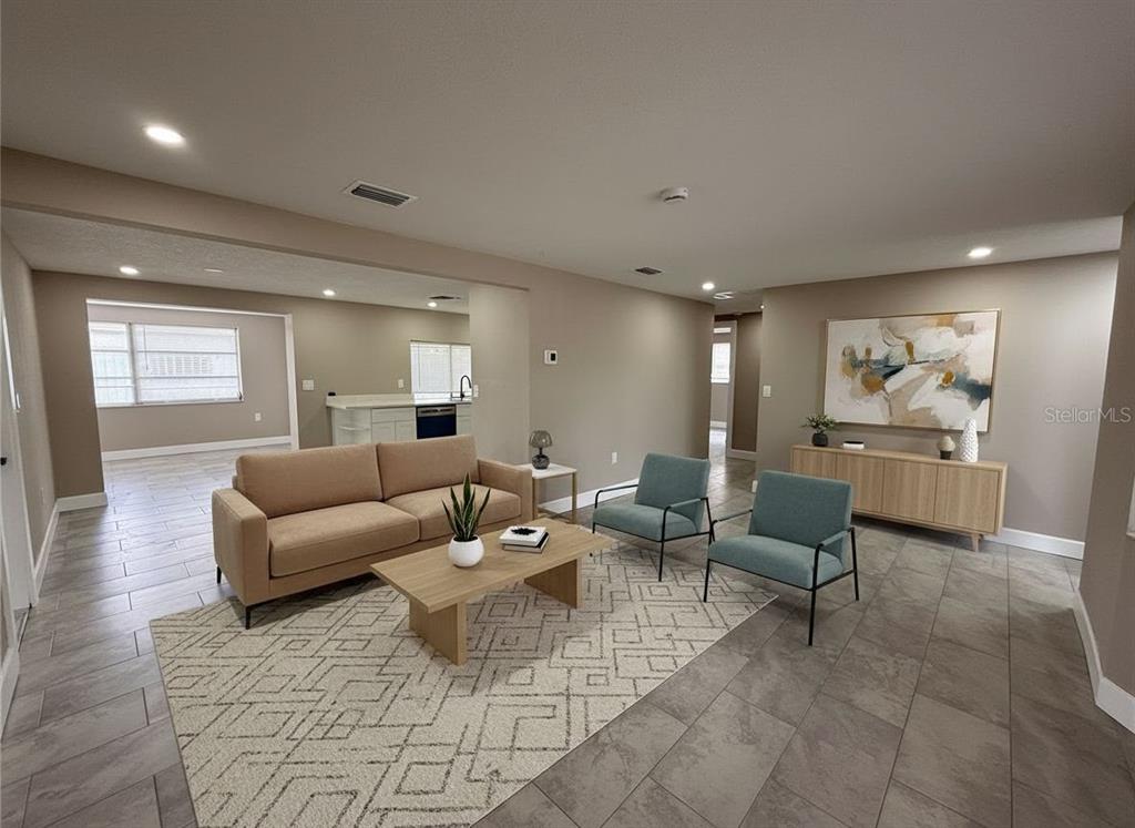 A modern kitchen features white cabinets, stainless steel appliances, and light wood-look flooring — 3019 LLOYD DRIVE, HOLIDAY, FL