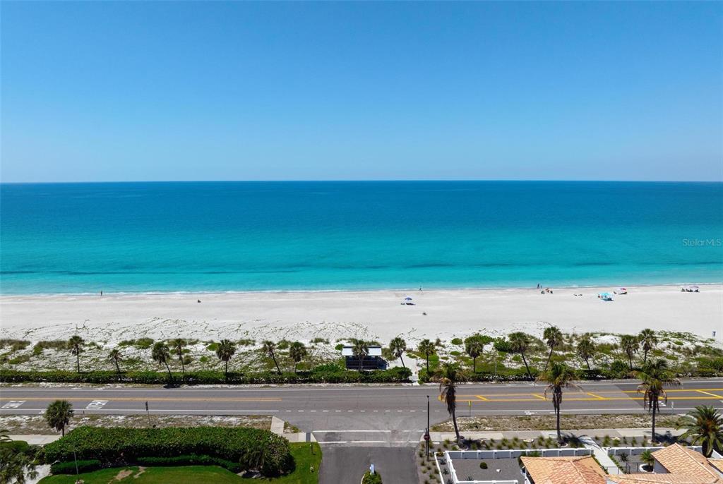 An aerial view shows a vacant waterfront lot situated between two modern houses — 581 ROUNTREE DRIVE, LONGBOAT KEY, FL