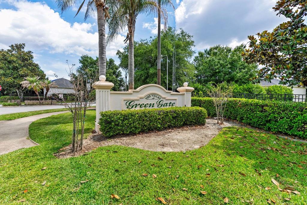 A beige stucco house with a three-car garage and a paved walkway — 1016 GREEN GATE BOULEVARD, GROVELAND, FL