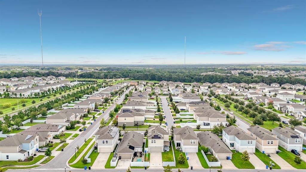 An aerial view shows a suburban neighborhood with rows of houses and paved streets — 13005 UPWARD PLACE, RIVERVIEW, FL