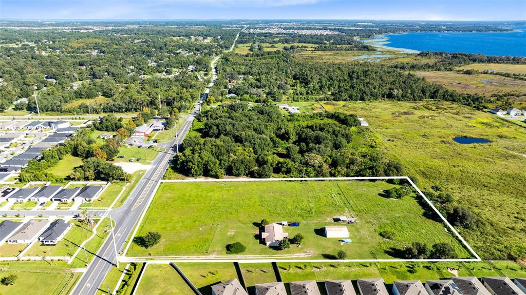 An aerial view shows a rectangular plot of land with a house and shed — 4125 HICKORY TREE ROAD, ST CLOUD, FL