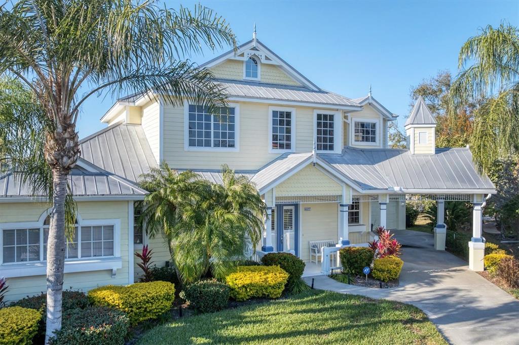 An aerial view of a residential neighborhood with houses situated along interconnected canals and waterways — 4627 BARRACUDA DRIVE, BRADENTON, FL
