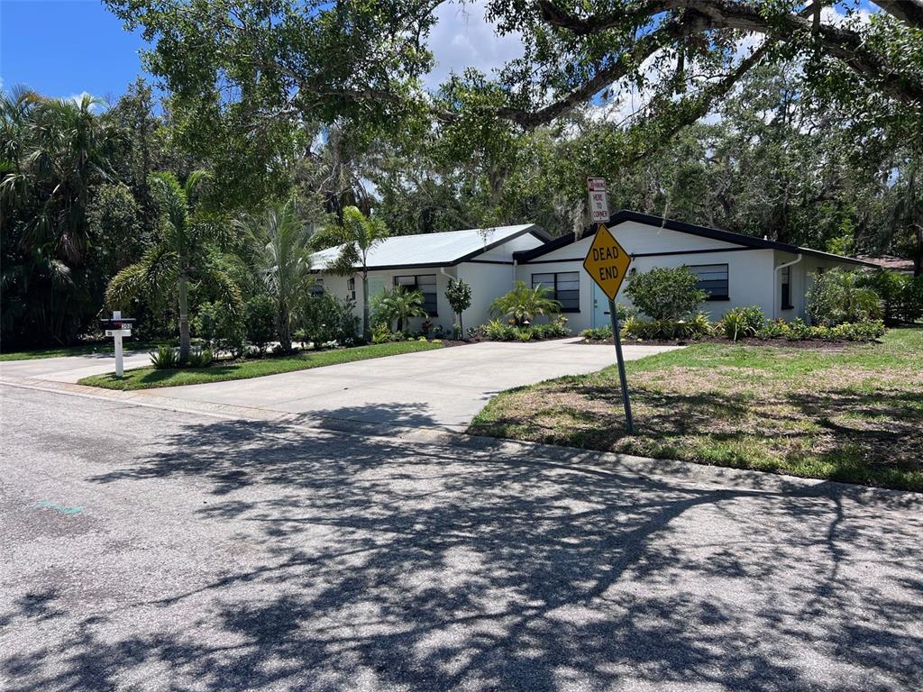 A single-story house with a concrete driveway and a dead end sign in the yard — 1840 3RD AVENUE E, BRADENTON, FL