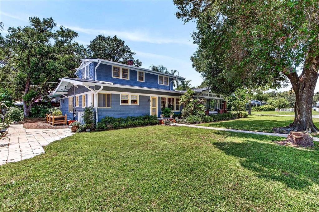 A two-story blue house with a large lawn and a stone patio — 1201 MAGNOLIA AVENUE, SANFORD, FL