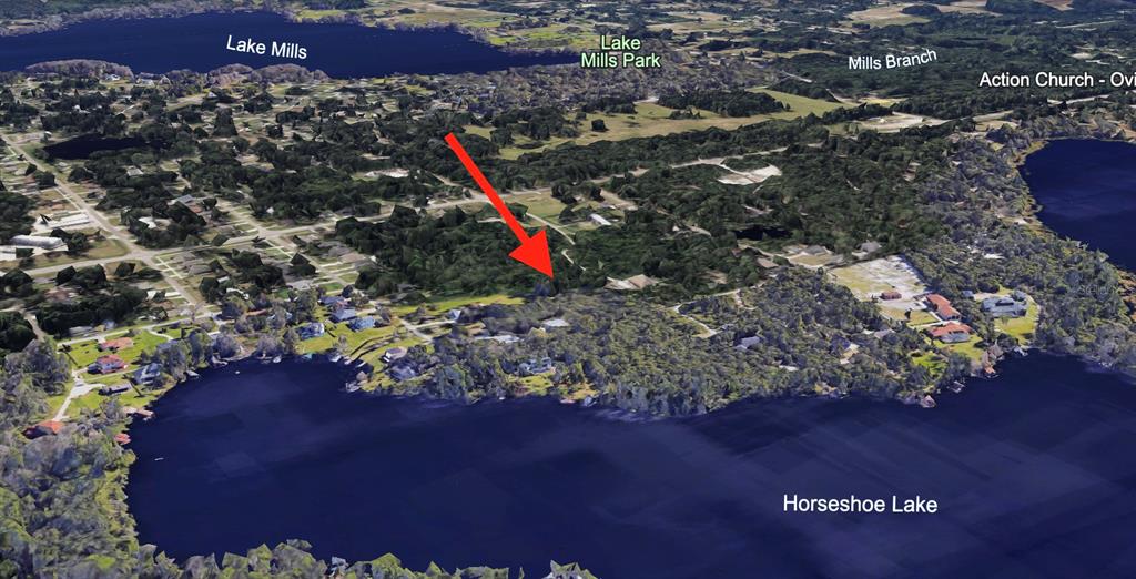 An aerial view of a wooded residential area situated between Lake Mills and Horseshoe Lake — 9TH AVENUE, CHULUOTA, FL