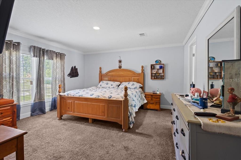 A kitchen island with a stainless steel farmhouse sink and dishwasher sits beneath blue tray ceilings — 87 NE 544TH STREET, OLD TOWN, FL