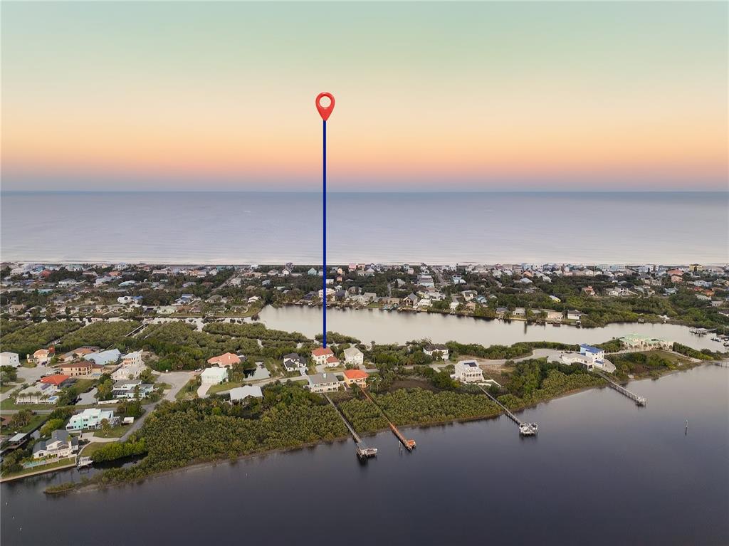 An aerial view shows a coastal neighborhood with a red location pin over a house — 2559 PALM AVENUE, FLAGLER BEACH, FL