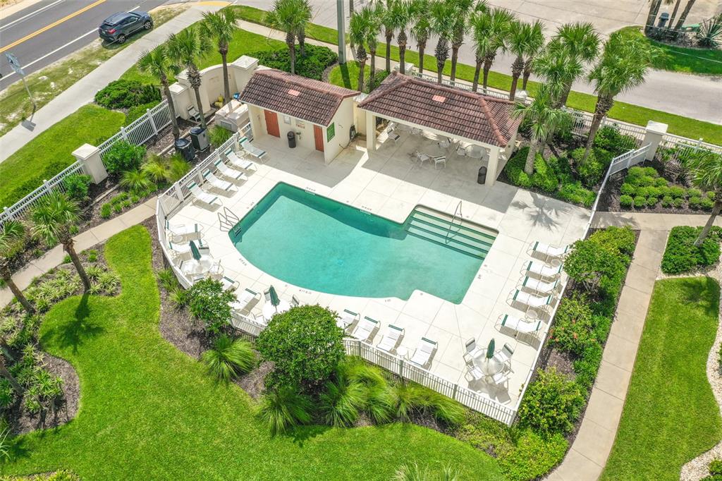 An aerial view of a swimming pool area with a covered pavilion and lounge chairs — 300 MARINA BAY DRIVE UNIT 106, FLAGLER BEACH, FL
