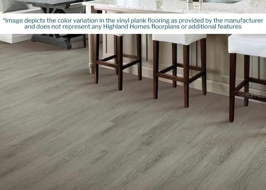 This image shows a kitchen area featuring light gray wood-look vinyl plank flooring — 6860 SUNDIAL DRIVE, LAKELAND, FL