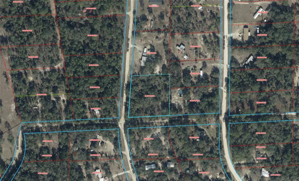 This is an aerial map showing multiple wooded residential lots and dirt roads — TBD NE 101ST TERRACE, ARCHER, FL