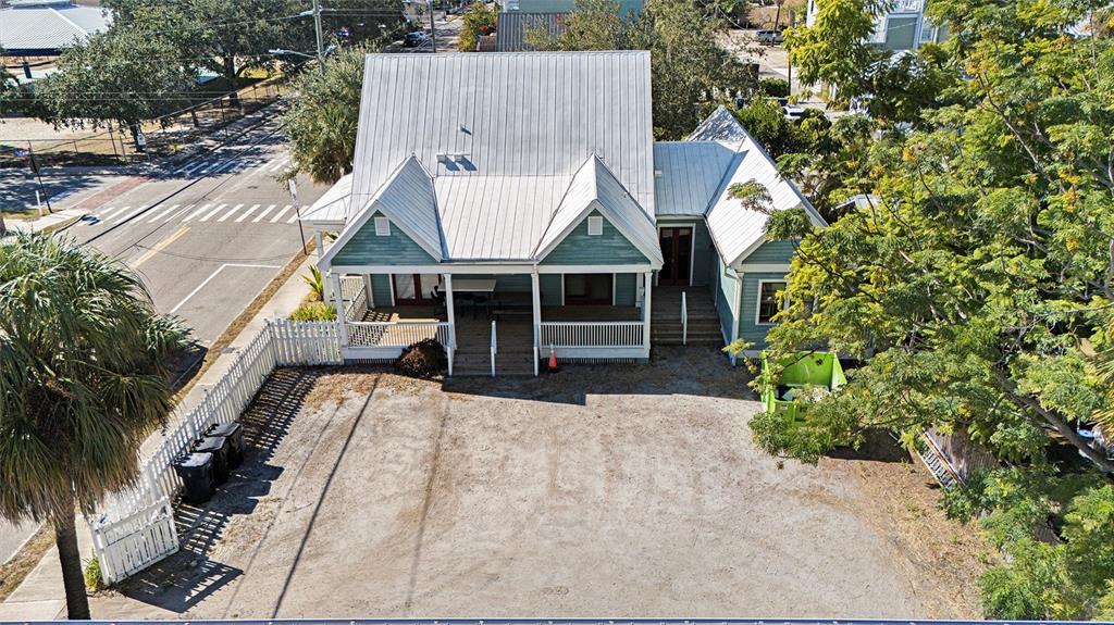 An aerial view of a teal house with a metal roof and a gravel driveway — 2002 E 4TH AVENUE, TAMPA, FL