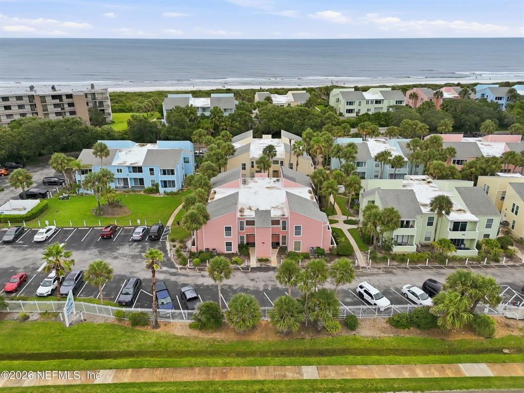 An aerial view shows several multi-story apartment buildings near a beach with parking lots — 6300 A1A S UNIT A92U, ST AUGUSTINE, FL
