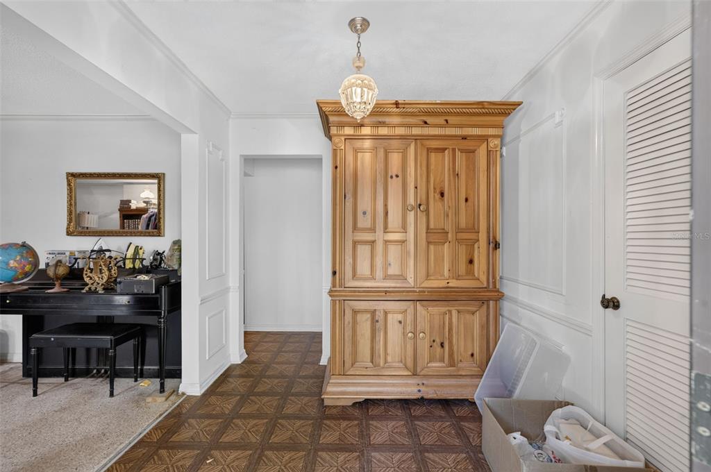 A foyer features a large wooden armoire, a black piano, and parquet flooring — 3513 MARWOOD DRIVE, ORLANDO, FL