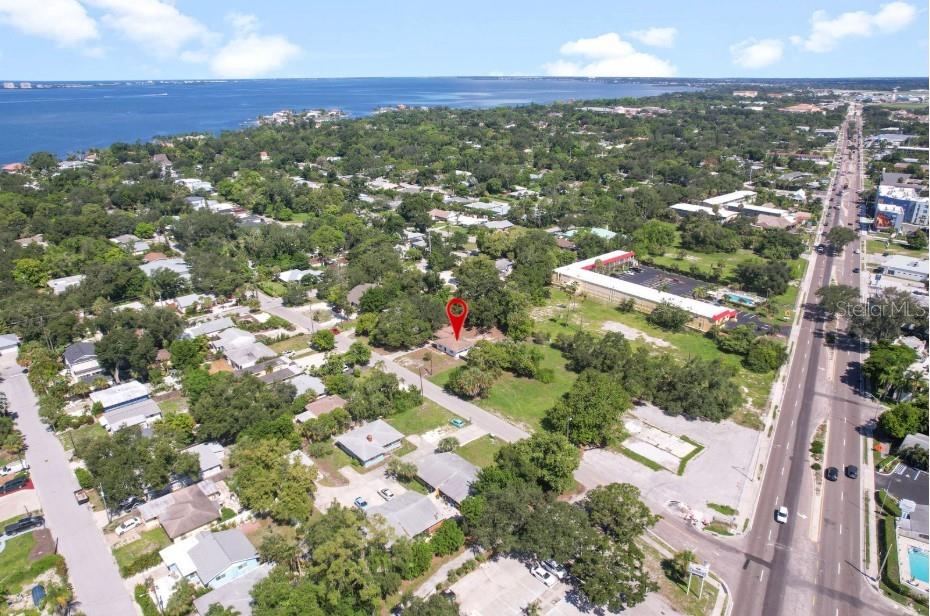 An aerial view shows a single-story house marked with a red pin in a neighborhood — 839 42ND STREET, SARASOTA, FL