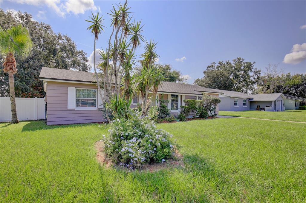 A single-story house with light brown siding, white shutters, and a front yard with landscaping — 2319 CONTINENTAL BOULEVARD, ORLANDO, FL