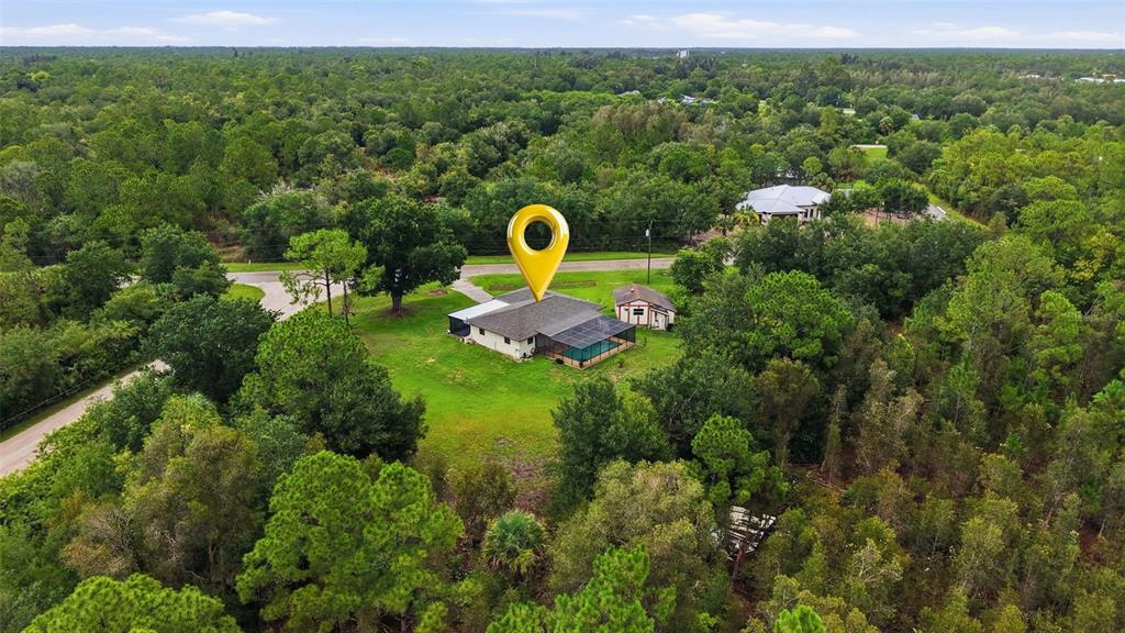 An aerial view shows a single-story house with a pool and shed surrounded by trees — 28265 MORNINGSIDE DRIVE, PUNTA GORDA, FL