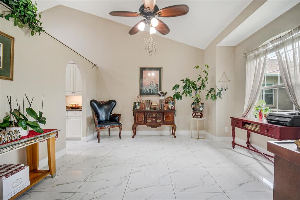 A bright entryway features white marble floors, a red double door, and a tall arched ceiling — 13522 HERON CAY COURT, ORLANDO, FL