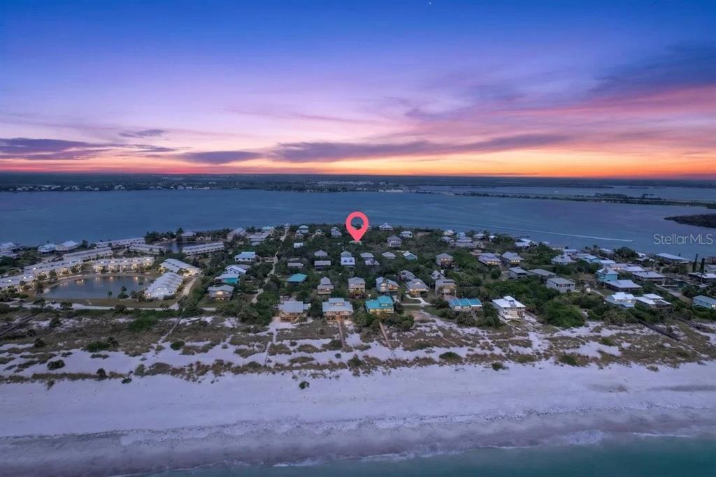 This aerial view shows a beachside community of houses with a red location pin — 9602 DOUBLOON TRAIL, PLACIDA, FL
