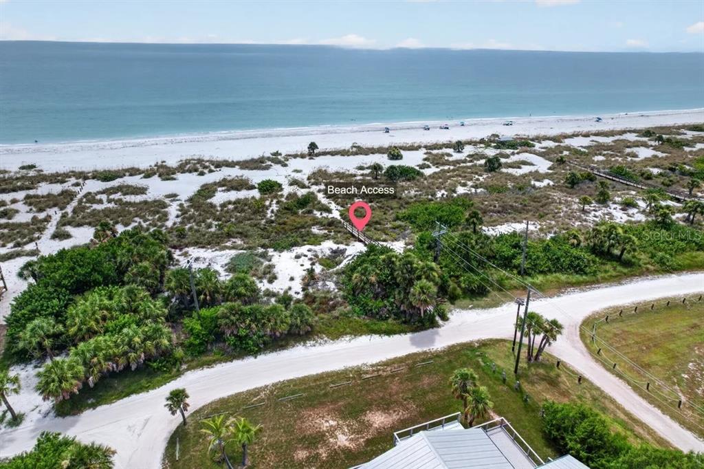 An aerial view shows a sandy path leading from a road to the beach — 9602 DOUBLOON TRAIL, PLACIDA, FL