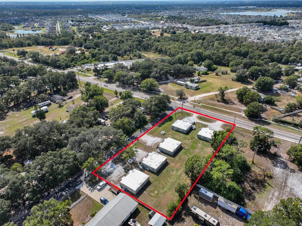 Aerial view of a rectangular lot containing five small, detached buildings with flat roofs — 11708 BALM RIVERVIEW ROAD, RIVERVIEW, FL
