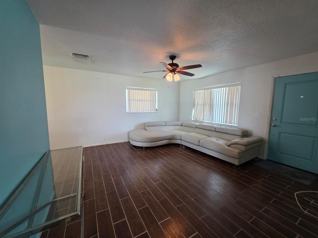 An aerial view of a residential neighborhood featuring a community pool and clubhouse — 3765 101ST AVENUE N UNIT -, PINELLAS PARK, FL