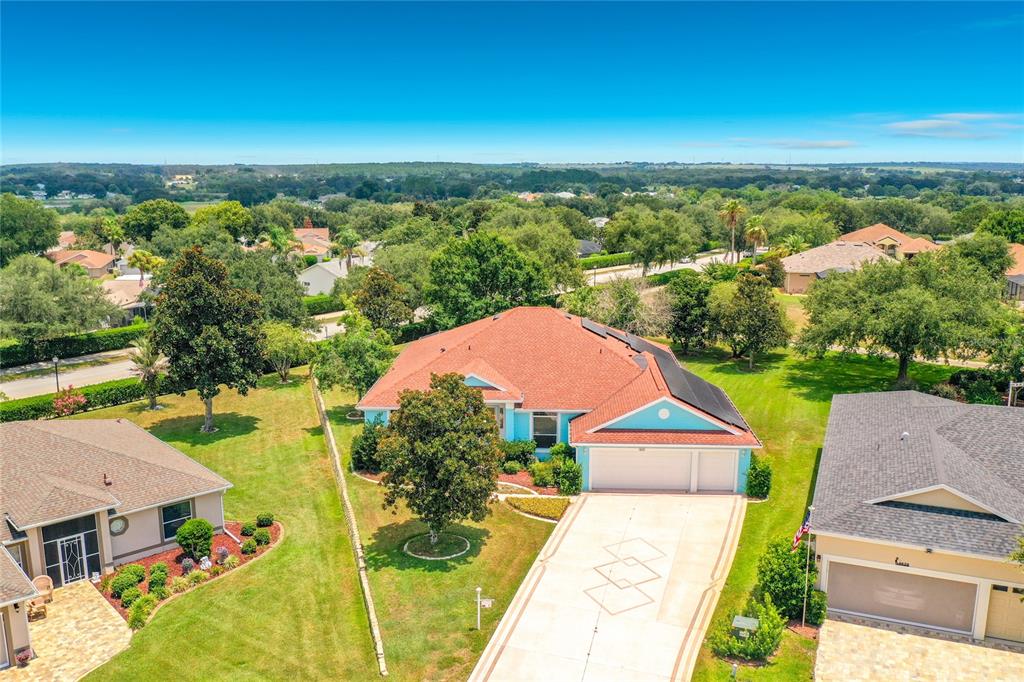 An aerial view shows a single-story house with a red roof and a paved driveway — 4632 NOTTOWAY, LEESBURG, FL