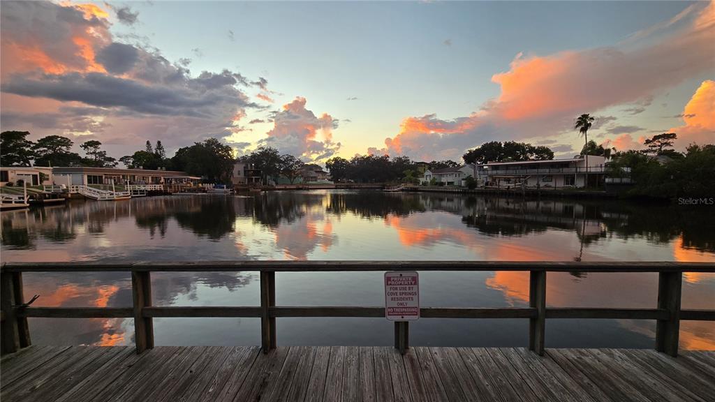 A kitchen features gray cabinets, a granite countertop island, and a stainless steel refrigerator — 4805 ALT 19 UNIT 624, PALM HARBOR, FL