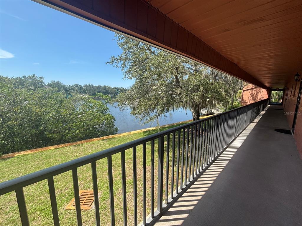 A kitchen features grey cabinets, stainless steel appliances, and granite countertops with a breakfast bar — 4805 ALT 19 UNIT 624, PALM HARBOR, FL