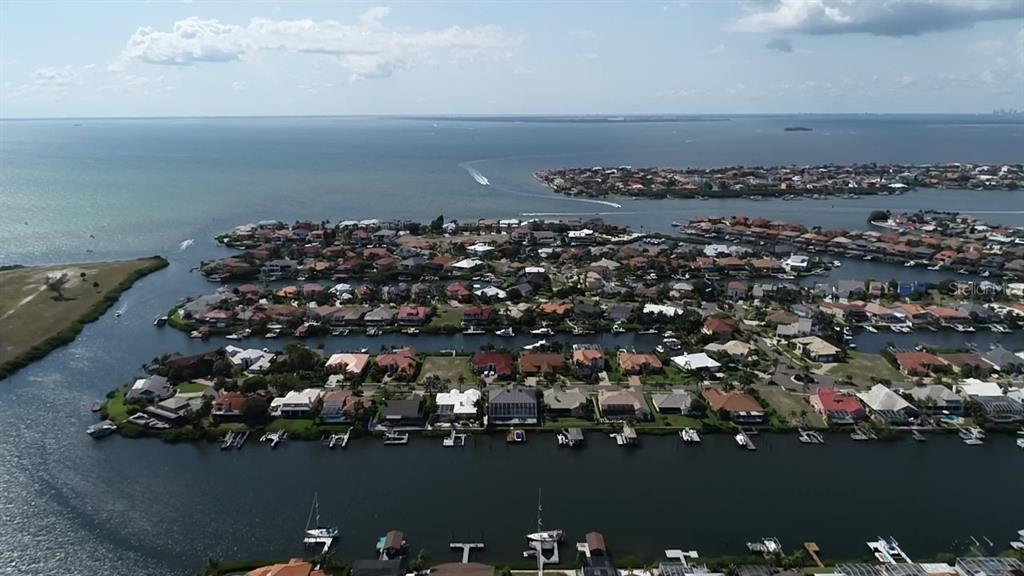 An aerial view of a waterfront residential neighborhood with canals, docks, and boats — 6451 RUBIA CIRCLE, APOLLO BEACH, FL