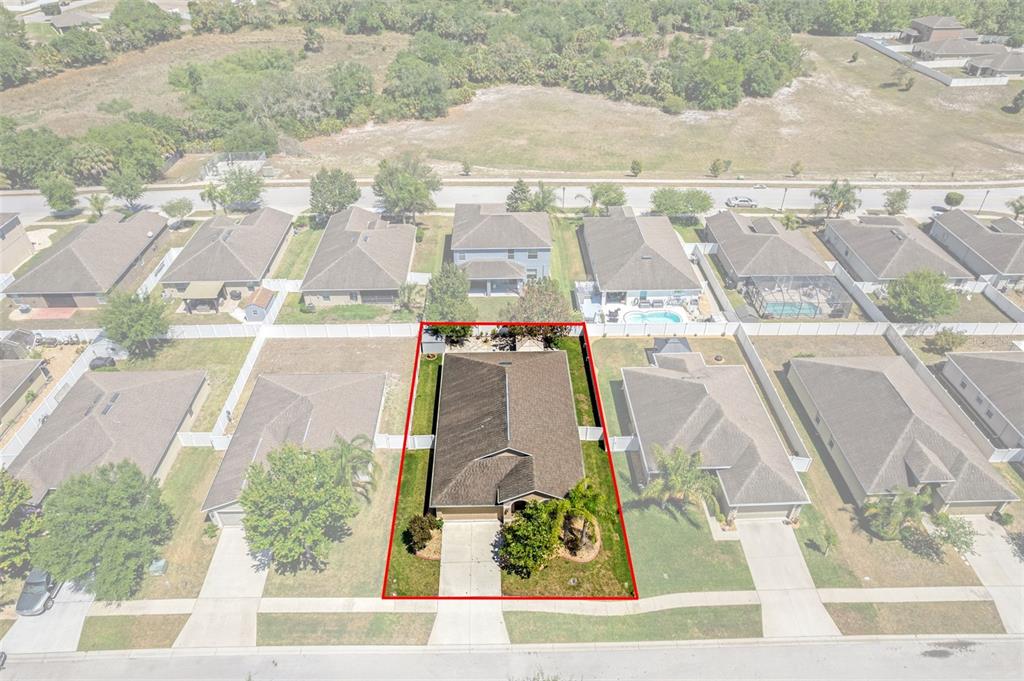 An aerial view shows a single-family house outlined in red within a suburban neighborhood — 18334 WAYDALE LOOP, HUDSON, FL