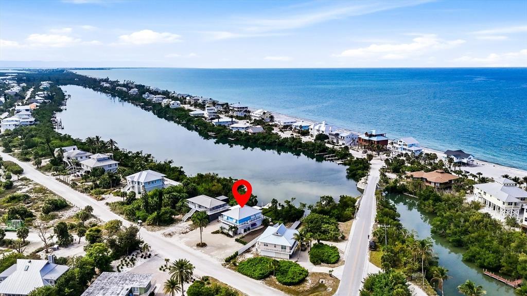 An aerial view shows a coastal neighborhood with a blue house marked by a pin — 21 BOCILLA DRIVE, PLACIDA, FL