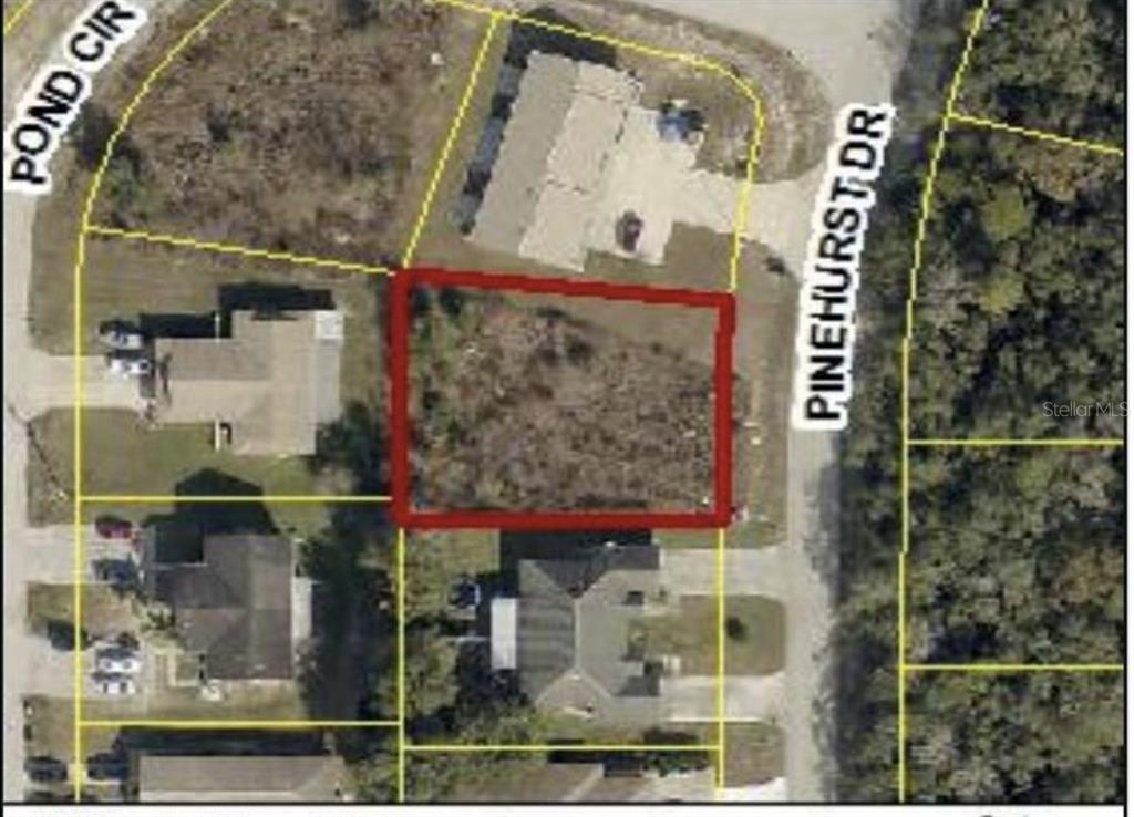 An aerial map view shows a vacant rectangular lot outlined in red between two streets — 7997 PINEHURST DRIVE, SPRING HILL, FL