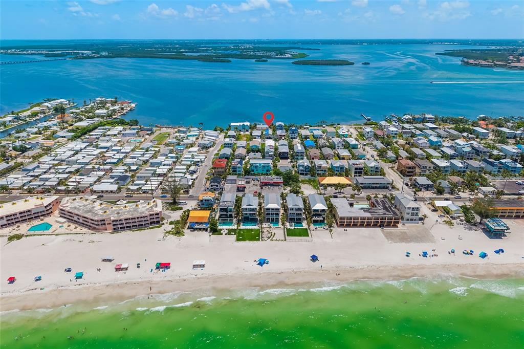 An aerial view of a beach town with a red location pin over a house — 2513 AVENUE B UNIT B, BRADENTON BEACH, FL